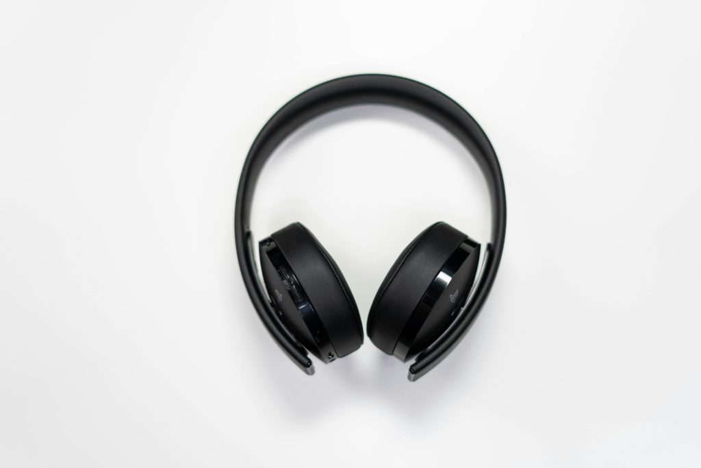 Black over-ear headphones placed on a white surface, perfect for tech and music themes.